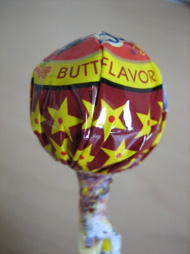 Lollipop with wrapper that is folded so that butterscotch flavor is Butt Flavor